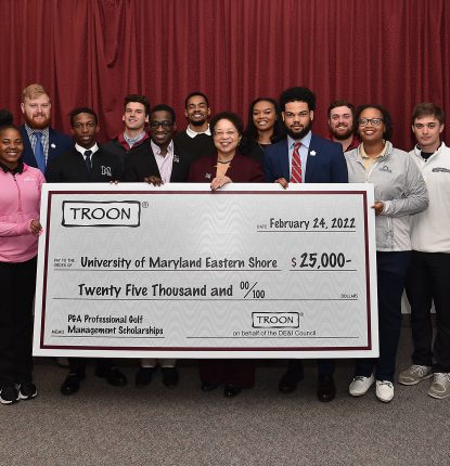 Picture of members of University of Maryland Eastern Shore holding a check for $25,000 from Troon.